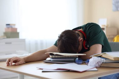 Kapalı alanda sınava hazırlanan yorgun öğrenci.