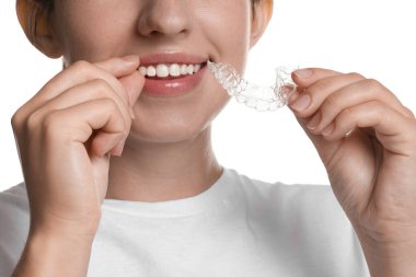 Beyaz arka planda diş hizalayan gülümseyen kadın, yakın plan.