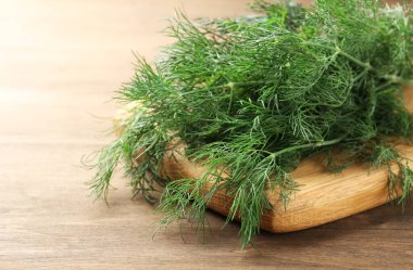 Ahşap masada taze dereotu var, yakın plan.