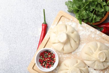 Pişmemiş khinkaliler (hamur tatlısı) ve hafif masada baharatlar, düz yatak. Metin için boşluk