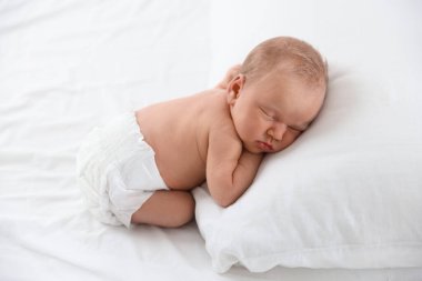 Yeni doğmuş şirin bebek evde yatakta uyuyor.
