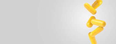 Açık gri arka plana düşen sarı haplar. Metin için alanı olan pankart tasarımı