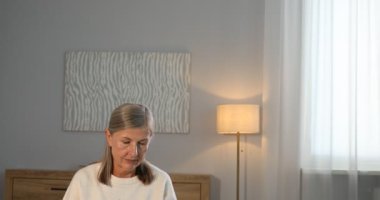 Evdeki kanepede kitap okuyan güzel bir son sınıf öğrencisi.