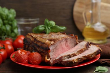 Lezzetli pişmiş et, domates ve fesleğen, yakın plan.