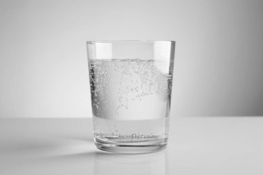 Kola suyunu açık ayna sehpasında gri gradyan arkaplan ile tazeliyorum. Yakın plan.