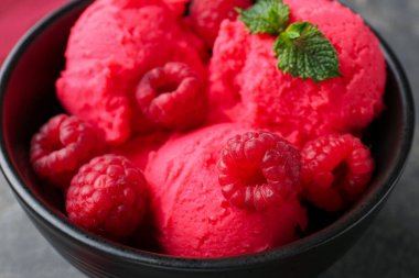 Lezzetli ahududu şerbeti, taze böğürtlen ve gri masada nane şekeri. Yakın plan.