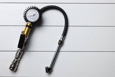 Açık gri ahşap masa üzerinde göstergesi olan bir enflasyon tabancası.