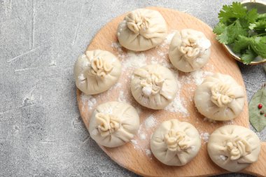 Pişmemiş khinkaliler (hamur köfteleri) gri masada, düz yerde. Metin için boşluk