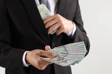 Arka planda dolar banknotları olan adam, yakın plan.