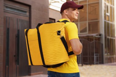 Şehir caddesinde termo çantalı bir kurye. Yemek dağıtım servisi.