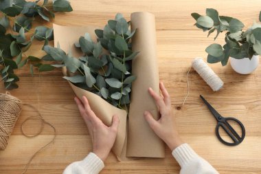 Çiçekçi okaliptüs dallarından güzel bir buket yapıyor.