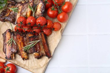 Biberiyeli biftek kaburgaları ve beyaz fayanslı domatesler, düz yatak. Metin için boşluk