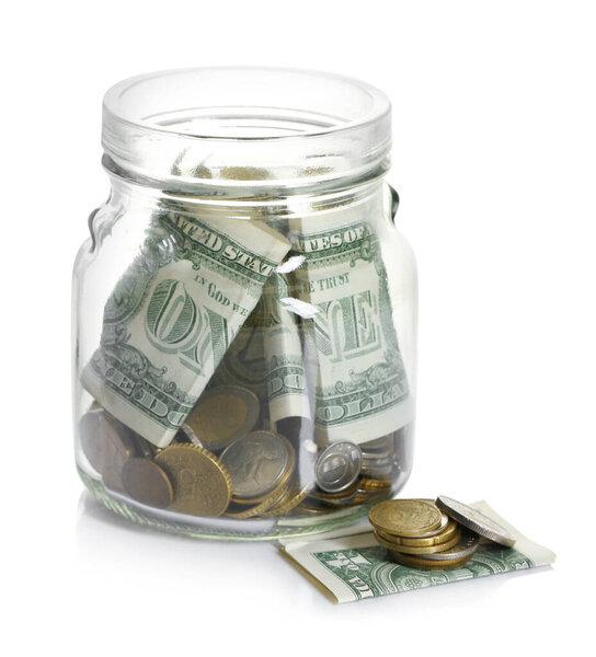 Glass jar with money isolated on white