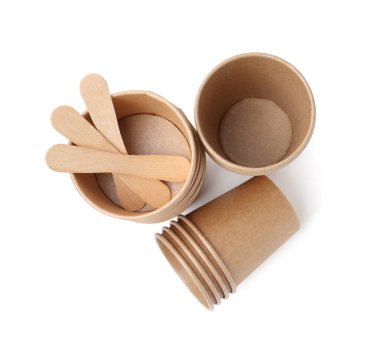 Set of disposable cups and wooden sticks isolated on white