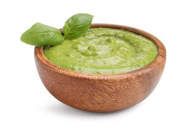 Pesto sauce with basil leaves in bowl isolated on white