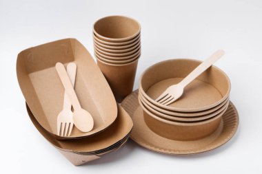Set of disposable tableware on white background, closeup