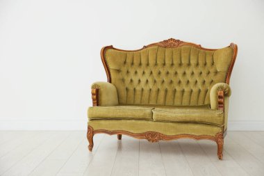 Beyaz duvarın yanındaki şık kanepe.