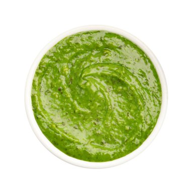 Fresh pesto sauce in bowl isolated on white, top view