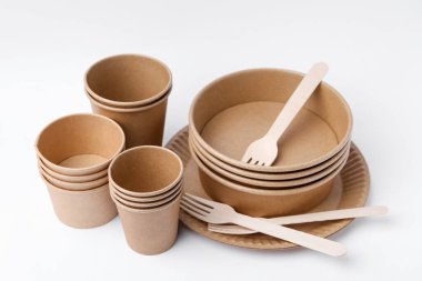 Set of disposable tableware on white background, closeup