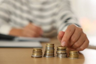 Tahta masada bozuk para sayan kadın, seçici odak