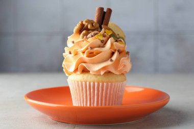 Gri masada kremalı, fındıklı ve tarçınlı kek, yakın plan.