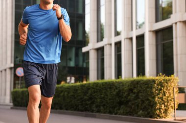 Spor giyimli bir adam dışarıda koşuyor, yakın plan. Metin için boşluk