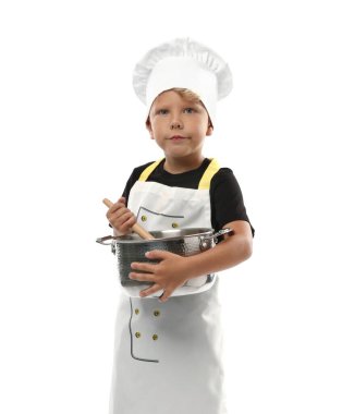 Meslek seçimi. Ot ve kaşıkla beyaz arka planda şef gibi davranan küçük çocuk
