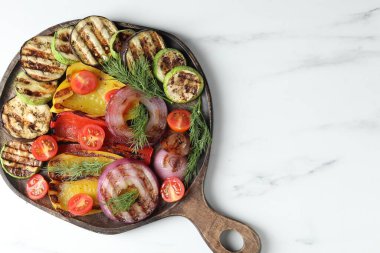 Vegetarian barbecue. Tasty grilled vegetables on white marble table, top view. Space for text