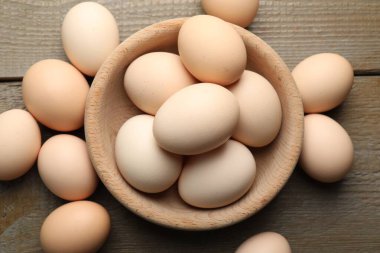 Fresh chicken eggs on wooden table, top view