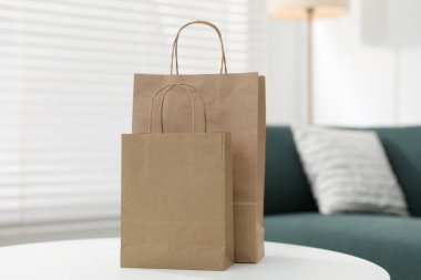Paper bags on white table indoors, closeup