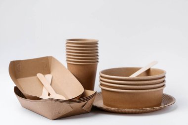 Set of disposable tableware on white background, closeup