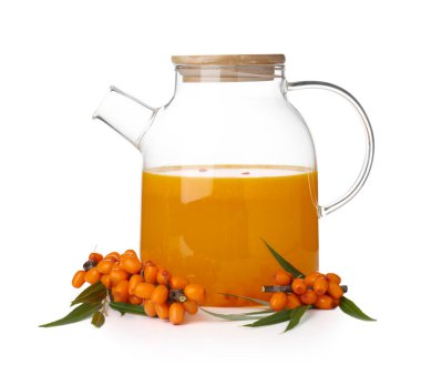 Sea buckthorn tea in glass teapot and fresh berries isolated on white