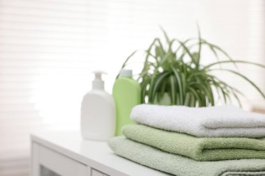 Banyodaki beyaz masanın üzerine temiz havlu yığını, yakın plan. Metin için boşluk