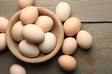 Fresh chicken eggs on wooden table, top view