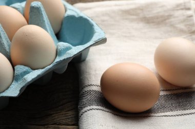 Fresh raw chicken eggs on table, closeup