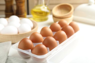 Beyaz masada çiğ tavuk yumurtası, yakın plan.