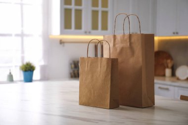 Mutfaktaki beyaz mermer masada kağıt torbalar. Metin için boşluk