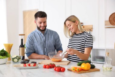 Mutfakta birlikte yemek pişiren mutlu çift.