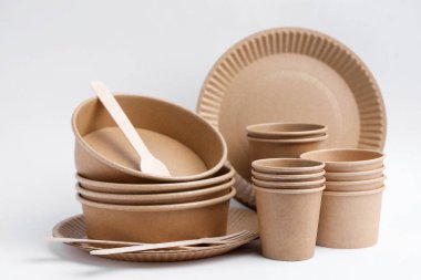 Set of disposable tableware on white background, closeup