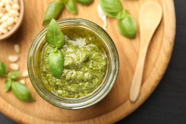 Kavanozda taze pesto sosu, siyah masada, üst tarafta.