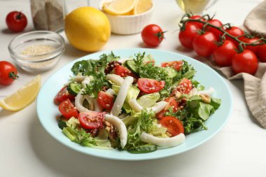 Delicious squid salad served on white table, closeup