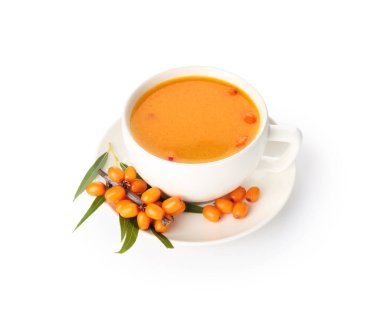 Cup of sea buckthorn tea and fresh berries isolated on white