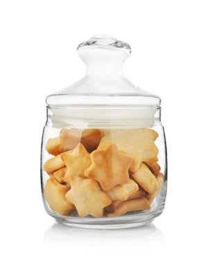 Glass jar with delicious cookies isolated on white