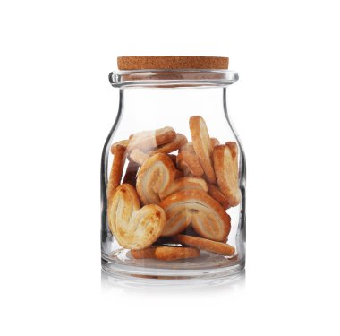 Glass jar with delicious cookies isolated on white