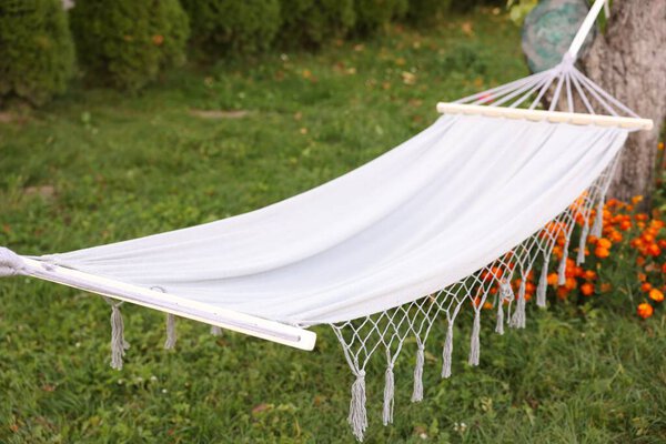 Empty comfortable white hammock in garden, closeup