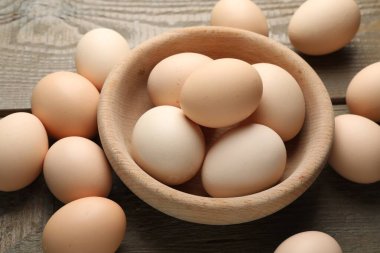 Fresh chicken eggs on wooden table, closeup