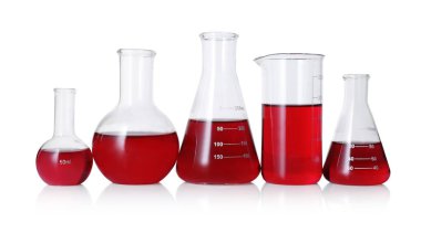 Different laboratory glassware with red liquid isolated on white