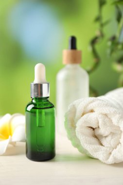 Beautiful spa composition with cosmetic product on white wooden table against blurred background, closeup