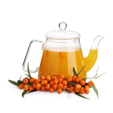Sea buckthorn tea in glass teapot and fresh berries isolated on white