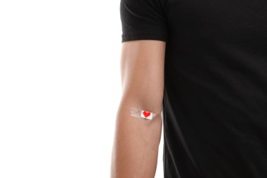 Kan bağışı. Kolu beyaz arkaplanda bandajlı adam, yakın plan.